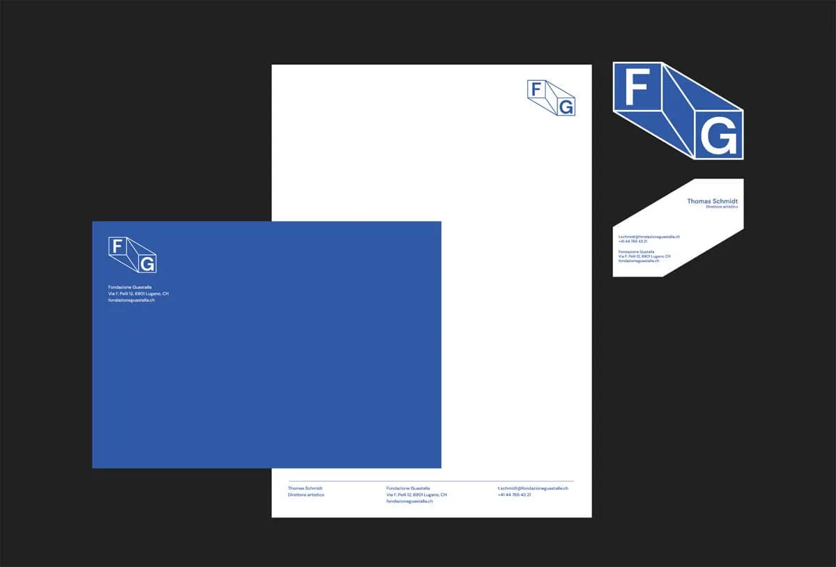 Stationery set including a blue envelope, white letterhead, business card, and a blue and white logo with letters F and G.