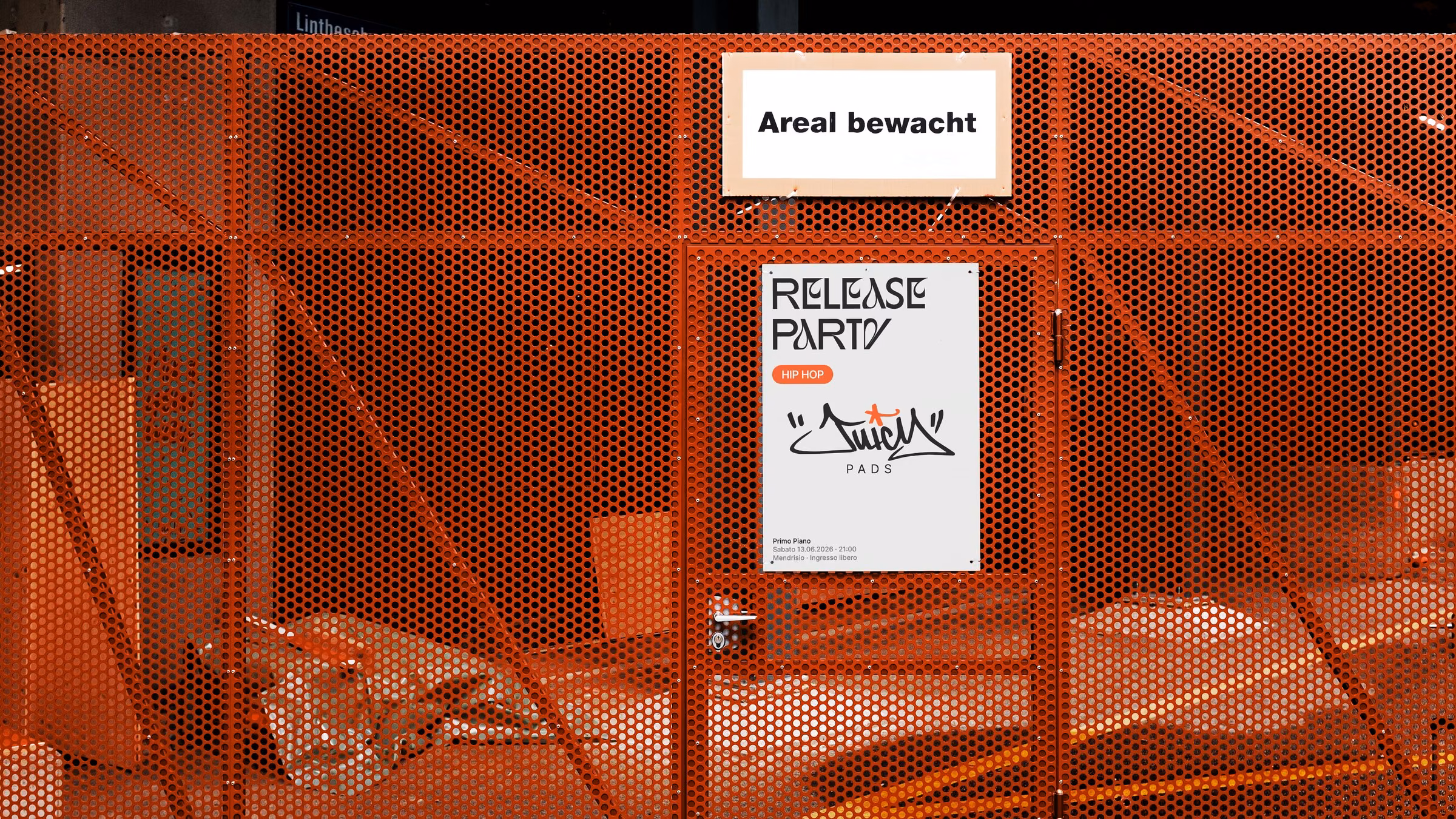 Primo Piano release party poster on an orange site fence