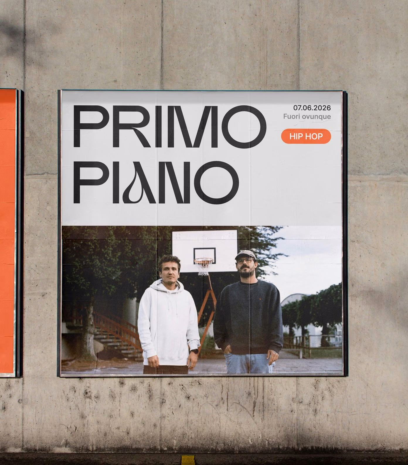Large Primo Piano poster on a concrete wall, with the photo of the two rappers at the basketball court