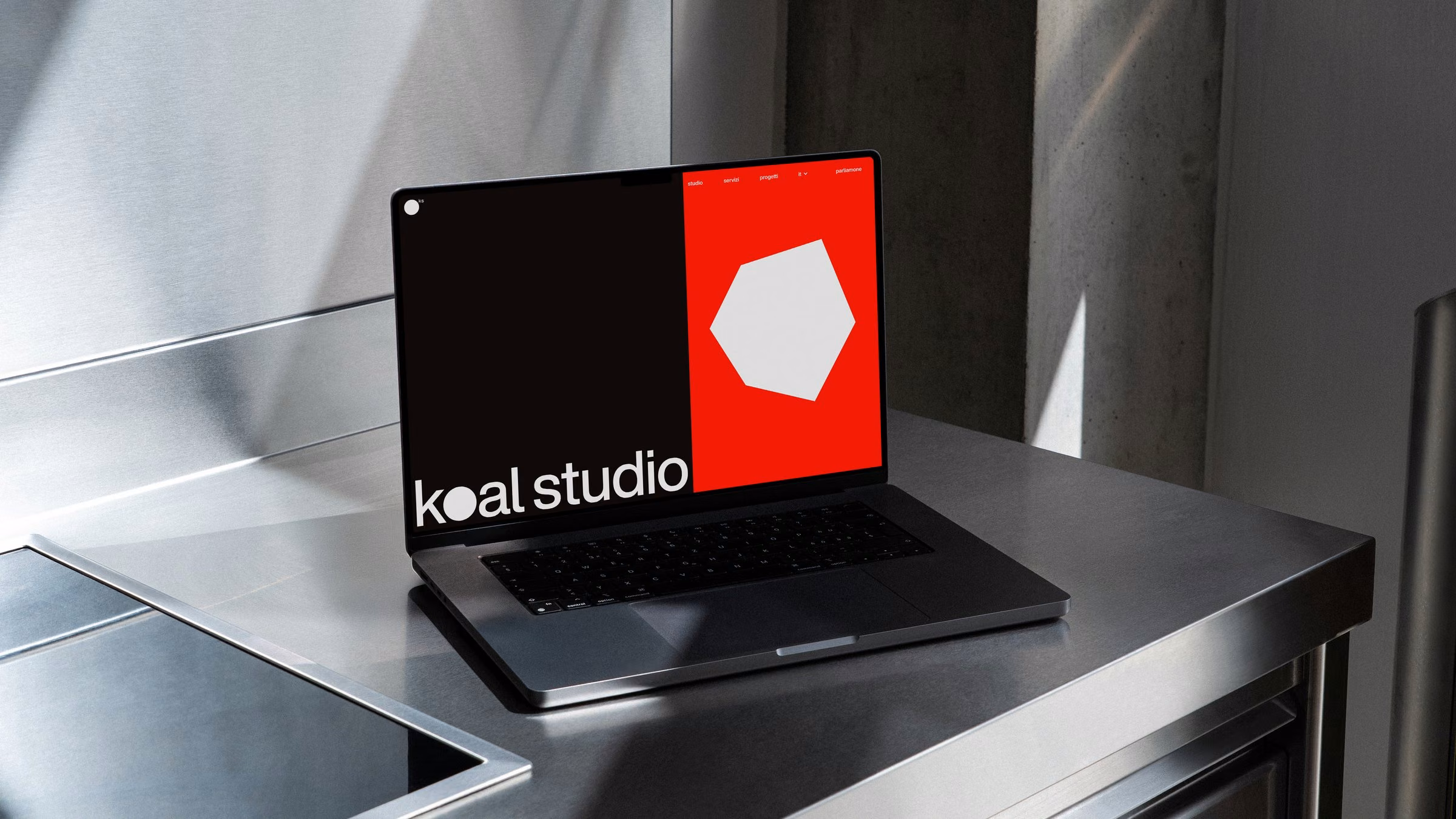 The Koal Studio home page on a laptop on a steel counter