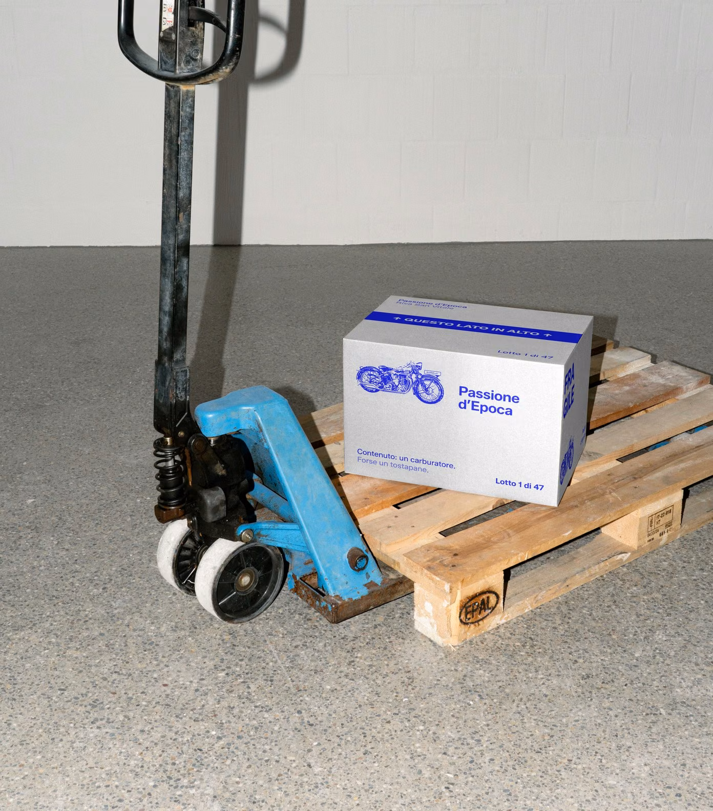 A Passione d’Epoca box on a pallet jack: lot 1 of 47