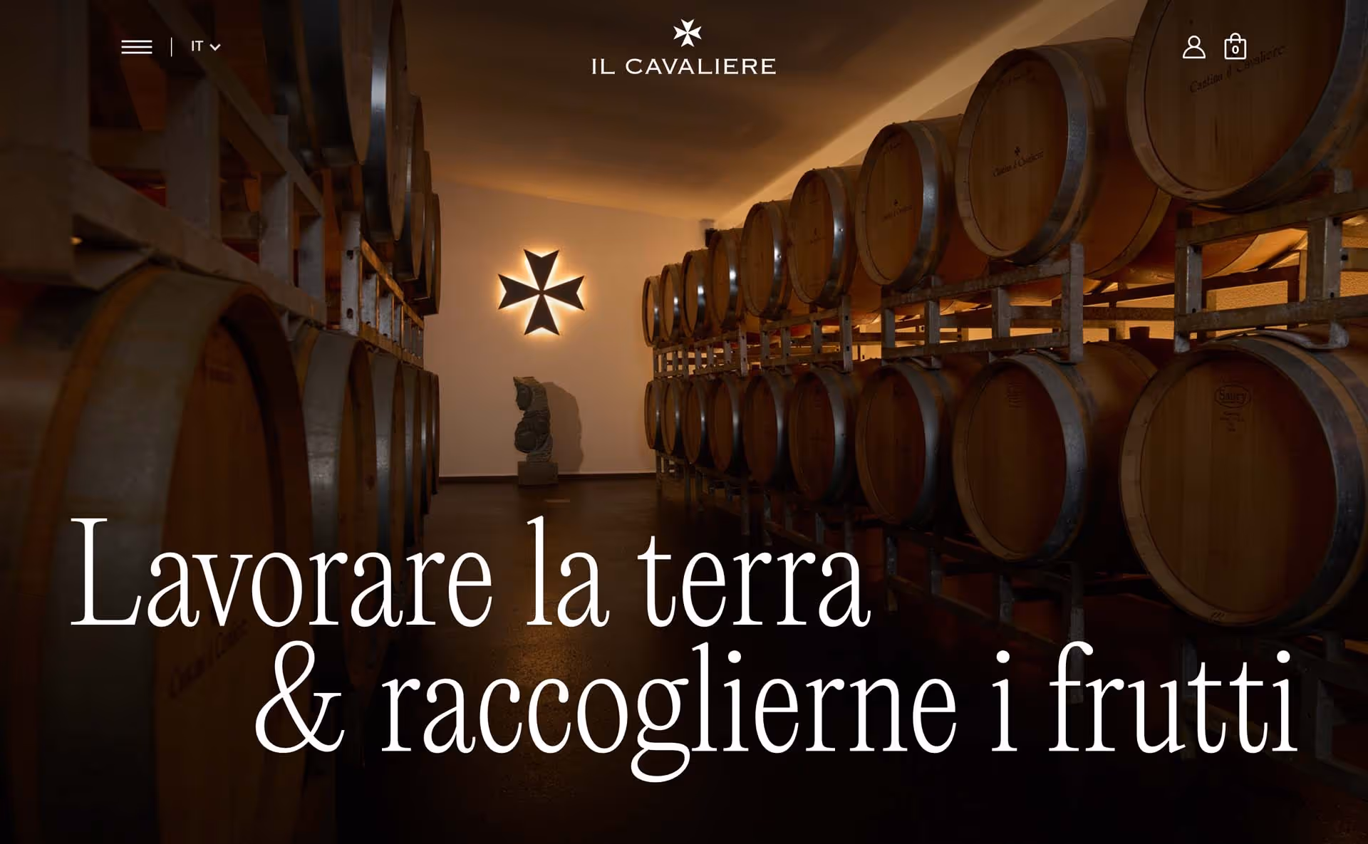 Interior of a wine cellar with wooden barrels on racks and an illuminated Maltese cross on the wall.