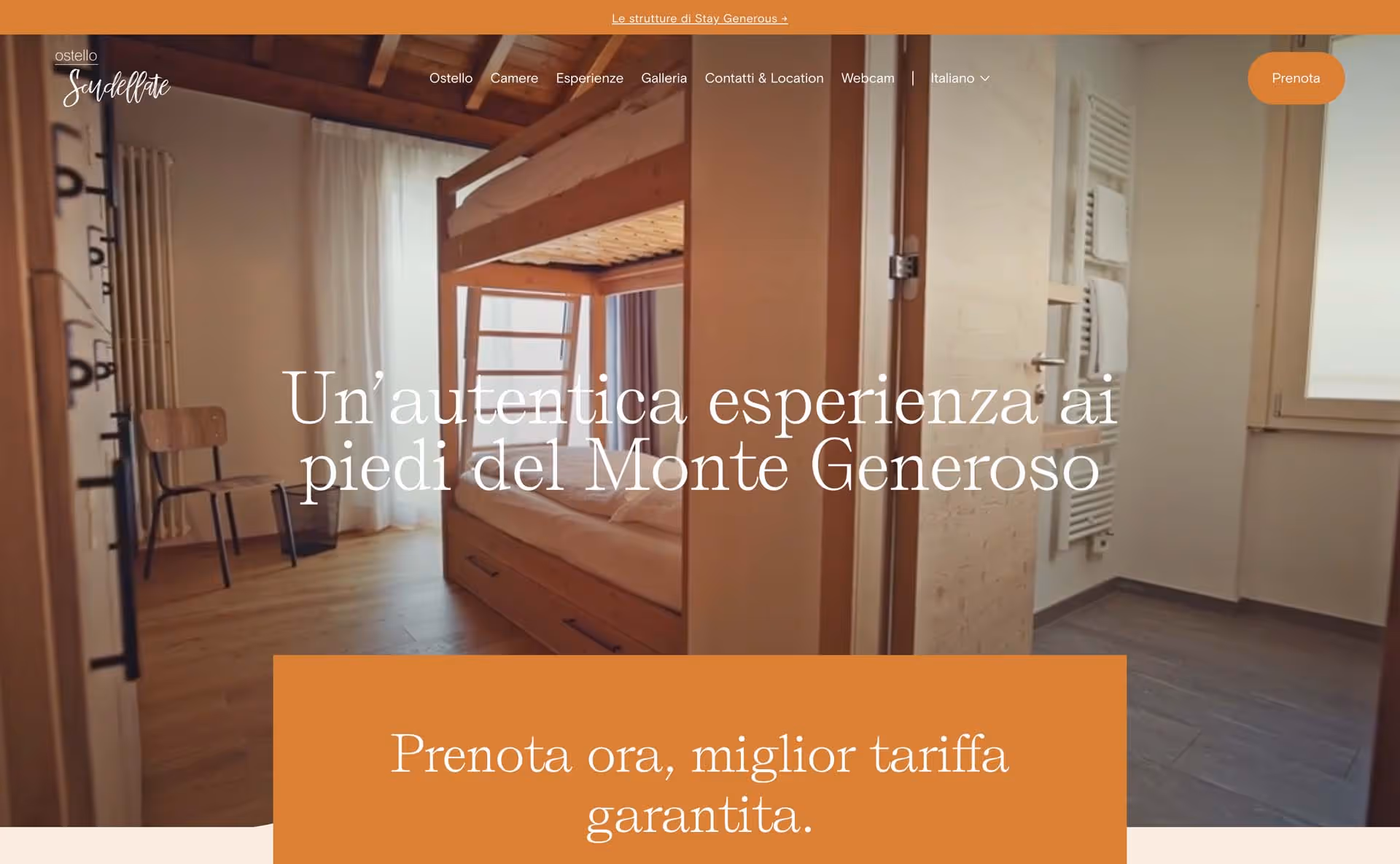 Interior of a hostel room with wooden bunk beds, a chair near the window, and an adjacent bathroom area.