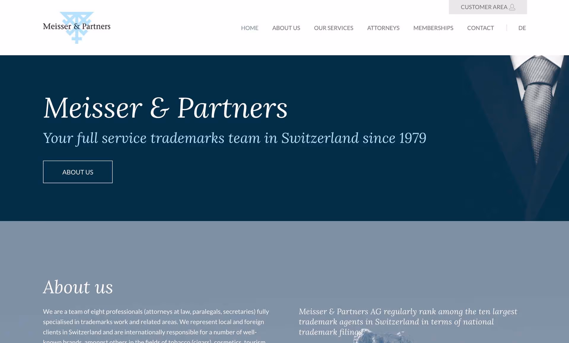 Website header for Meisser & Partners, a Swiss trademark team since 1979, with menu options and a suit and tie background.