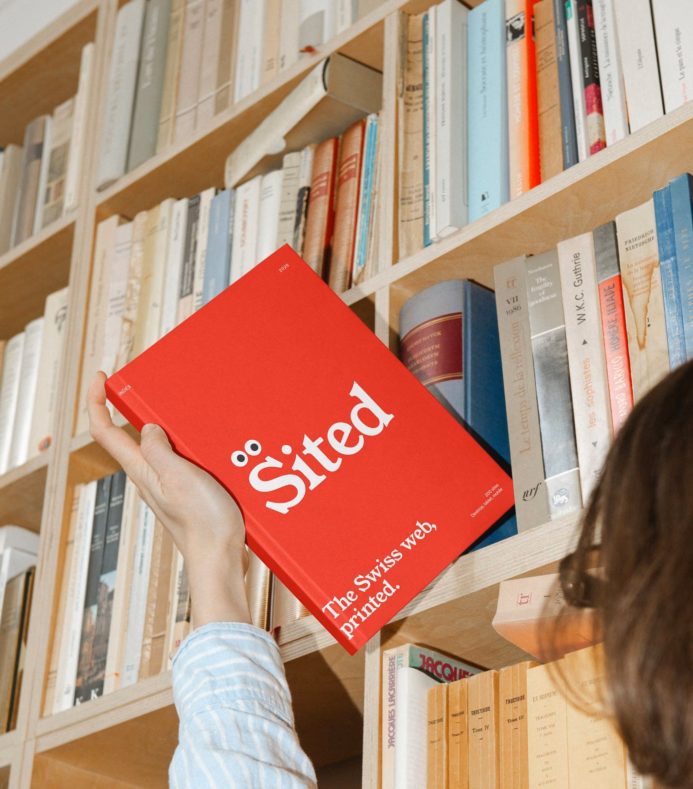 Sited Index 2026, the red yearbook, taken from the bookshelf: the Swiss web, printed