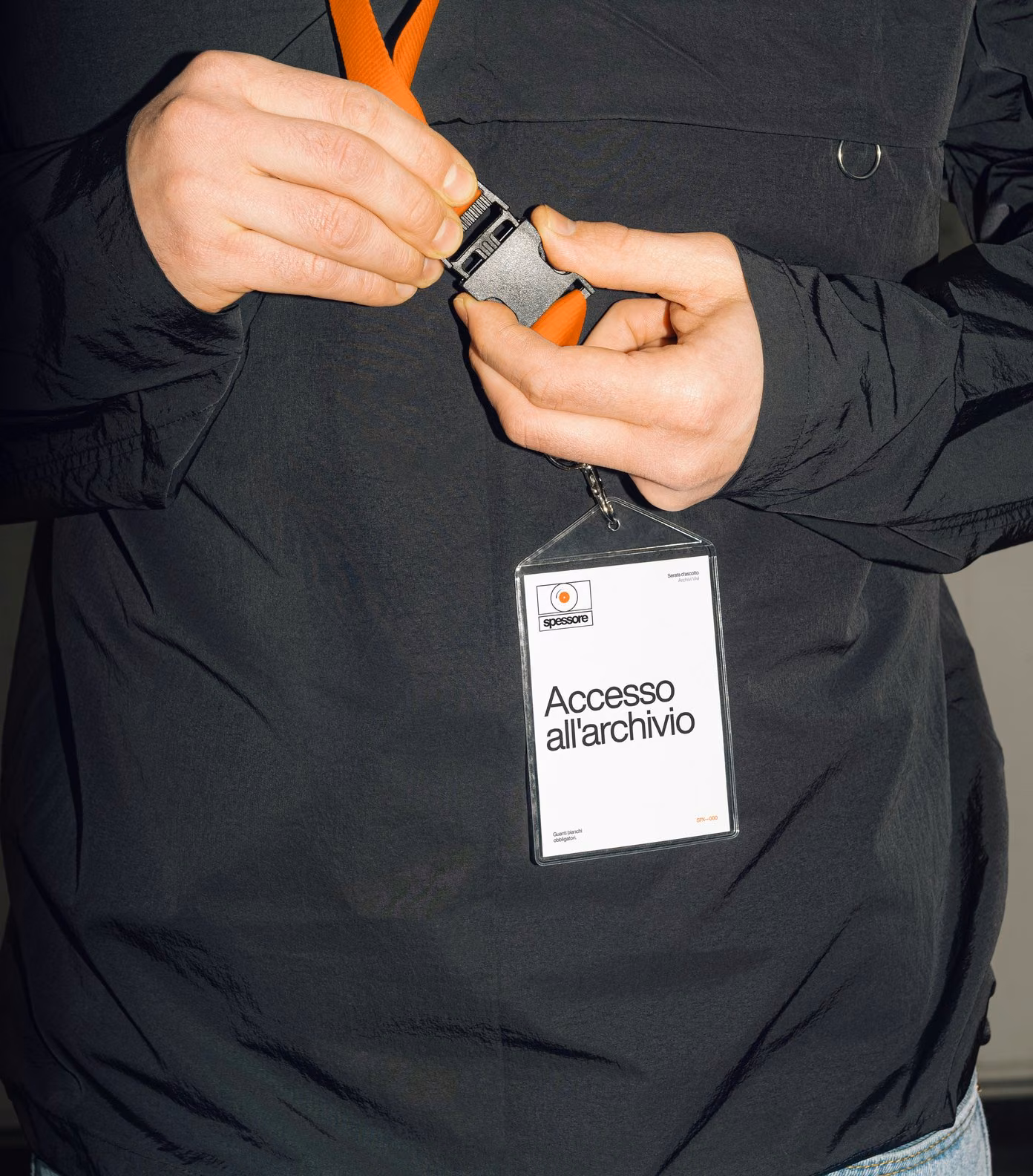 Pass for the Archivi Vivi listening night on an orange lanyard: access to the archive